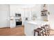 Well-lit kitchen featuring white cabinets, a breakfast bar, and stainless steel appliances at 220 Chandeleur Dr, Mooresville, NC 28117