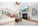 Bright and airy living room with a fireplace, plush seating, and expansive windows with natural light at 220 Chandeleur Dr, Mooresville, NC 28117