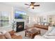 Inviting living room featuring a fireplace, ceiling fan, and a comfortable seating area with leather furniture at 220 Chandeleur Dr, Mooresville, NC 28117