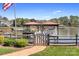 Waterfront property with dock featuring covered boat slips and charming landscaping at 220 Chandeleur Dr, Mooresville, NC 28117