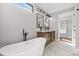 A luxurious bathroom with a freestanding tub, double vanity, marble floors and walk-in closet at 2200 Stratford Ave, Charlotte, NC 28205