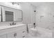 Modern bathroom with marble tile, a sleek vanity, and a tub-shower combination at 2200 Stratford Ave, Charlotte, NC 28205