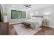 Bright bedroom featuring a large bed, three windows, hardwood floors and neutral decor at 2200 Stratford Ave, Charlotte, NC 28205