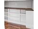 Custom built-in shelving with wood countertop and white cabinets above hardwood floors at 2200 Stratford Ave, Charlotte, NC 28205