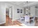 Bright dining area featuring a round table, six chairs, wood floors, and modern lighting at 2200 Stratford Ave, Charlotte, NC 28205