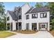 Stunning two-story home with white siding, dark trim, covered parking, and manicured landscaping at 2200 Stratford Ave, Charlotte, NC 28205