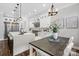 A modern kitchen featuring white cabinets, a large island, stainless steel appliances, and a dining area at 2200 Stratford Ave, Charlotte, NC 28205