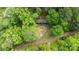Aerial view of the home nestled among lush greenery, offering privacy and a natural setting at 2275 Brown Creek Church Rd, Wadesboro, NC 28170