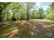 Property featuring a large, treed backyard and outbuildings at 2275 Brown Creek Church Rd, Wadesboro, NC 28170