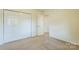 Carpeted bedroom with a closet and entry door, offering a cozy and functional space at 266 Kelly St, Statesville, NC 28677