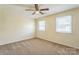 Bright bedroom featuring a ceiling fan, carpet, and two windows, creating a comfortable retreat at 266 Kelly St, Statesville, NC 28677