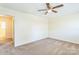 Comfortable carpeted bedroom features a ceiling fan, carpet, and an open entry door, creating a welcoming atmosphere at 266 Kelly St, Statesville, NC 28677