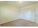 Cozy bedroom with neutral carpet, a double door closet, and a flush ceiling light at 266 Kelly St, Statesville, NC 28677