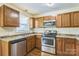 Well-equipped kitchen with stainless steel appliances and wooden cabinetry at 266 Kelly St, Statesville, NC 28677