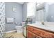 Bathroom with blue walls, a shower and tub combination, and wood-look flooring at 2703 Plantation Way, Albemarle, NC 28001