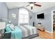 Comfortable bedroom with a large window, TV, and a cozy bed with hardwood floors at 2703 Plantation Way, Albemarle, NC 28001