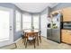 Dining area featuring a wooden table with tile flooring and natural light at 2703 Plantation Way, Albemarle, NC 28001