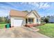 Charming single-story home with a cozy front porch, attached garage, and well-maintained lawn at 2703 Plantation Way, Albemarle, NC 28001