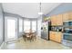 Eat-in kitchen featuring a stainless steel refrigerator, wood cabinets and tile floor at 2703 Plantation Way, Albemarle, NC 28001