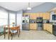 Bright eat-in kitchen with stainless steel refrigerator, wood cabinets, and round dining table at 2703 Plantation Way, Albemarle, NC 28001
