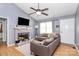 Inviting living room with vaulted ceiling, fireplace, and natural light, perfect for relaxing at 2703 Plantation Way, Albemarle, NC 28001