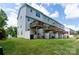 A view of backyards of townhouses, each with a small wooden deck and a white privacy fence at 2932 Pirates Pl, Charlotte, NC 28216