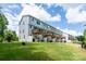 Backyards of townhouses, each with a small wooden deck and a white privacy fence, overlooking a grassy lawn at 2932 Pirates Pl, Charlotte, NC 28216