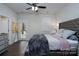 Well-lit bedroom with a bed, ceiling fan, and access to a back porch at 2932 Pirates Pl, Charlotte, NC 28216