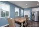 Inviting dining area featuring a rustic wood table, stylish chairs, and natural light from the windows at 2932 Pirates Pl, Charlotte, NC 28216