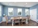 Inviting dining area featuring a rustic wood table, stylish chairs, and natural light from the windows at 2932 Pirates Pl, Charlotte, NC 28216