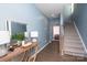 Hallway with blue walls with console table and mirror at 2932 Pirates Pl, Charlotte, NC 28216