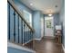 Bright entryway with blue walls, wooden floors, and a staircase at 2932 Pirates Pl, Charlotte, NC 28216