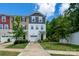 Townhouse with neutral vinyl siding, a one-car garage and well-maintained lawn with shrubbery and a young tree at 2932 Pirates Pl, Charlotte, NC 28216