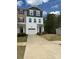 View of a well-maintained townhome with a driveway and attached garage on a sunny day at 2932 Pirates Pl, Charlotte, NC 28216