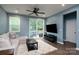 Cozy living room with a comfortable sofa, ceiling fan, and access to the outdoor deck at 2932 Pirates Pl, Charlotte, NC 28216