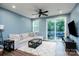 Cozy living room with a comfortable sofa, ceiling fan, and access to the outdoor deck at 2932 Pirates Pl, Charlotte, NC 28216