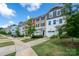 Modern townhome exteriors with colorful accents, garages, and landscaped front yards at 2932 Pirates Pl, Charlotte, NC 28216