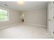 Bright bedroom with neutral walls and plush carpet has doorway access at 3005 Kenninghall Ct, Charlotte, NC 28269