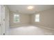 Bright bedroom has carpeted floors and features two windows for ample natural light at 3005 Kenninghall Ct, Charlotte, NC 28269