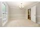 Spacious dining room with a chandelier and ample natural light, ideal for gatherings at 3005 Kenninghall Ct, Charlotte, NC 28269