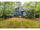 Exterior view of the home with a well-maintained lawn, deck and backyard providing ample space for outdoor activities at 3005 Kenninghall Ct, Charlotte, NC 28269