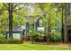 Charming blue two-story home with lush landscaping and a side-entry garage, offering curb appeal at 3005 Kenninghall Ct, Charlotte, NC 28269