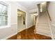 Bright foyer with hardwood floors, a staircase, and views into the dining and living areas at 3005 Kenninghall Ct, Charlotte, NC 28269
