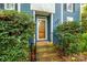 Inviting front entrance featuring a decorative door, brick steps, and manicured greenery at 3005 Kenninghall Ct, Charlotte, NC 28269