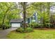 Charming two-story home with blue siding, a well-manicured lawn, and mature trees in a serene neighborhood setting at 3005 Kenninghall Ct, Charlotte, NC 28269