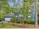 Two-story home with blue siding, manicured landscaping, and a tree-lined yard creating a picturesque curb appeal at 3005 Kenninghall Ct, Charlotte, NC 28269
