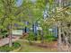 Charming two-story home with blue siding, well-maintained lawn, and a mature tree providing shade and character at 3005 Kenninghall Ct, Charlotte, NC 28269