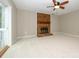 Inviting living room with a brick fireplace, ceiling fan, and new carpeting at 3005 Kenninghall Ct, Charlotte, NC 28269