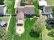 Aerial view of a fenced backyard showcasing a patio, fire pit, wood deck, and lush green lawn at 3530 Farm Lake Sw Dr, Concord, NC 28027
