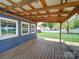 Outdoor deck providing wooden floors and ceiling, backyard view, string lighting, and blue siding at 3530 Farm Lake Sw Dr, Concord, NC 28027